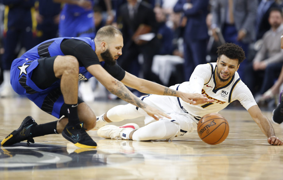 Orlando Magic guard Evan Fournier (10) goes for the ball against Denver Nuggets guard Jamal Murray (27) for a loose ball during the second half at Amway Center.
