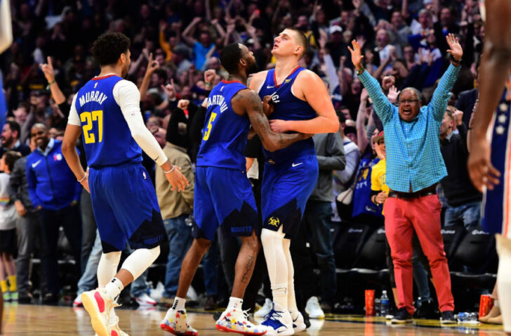 Denver Nuggets center Nikola Jokic (15) is congratulated for his three point basket by forward Will Barton (5) and guard Jamal Murray (27) in the fourth quarter against the Philadelphia 76ers at the Pepsi Center.