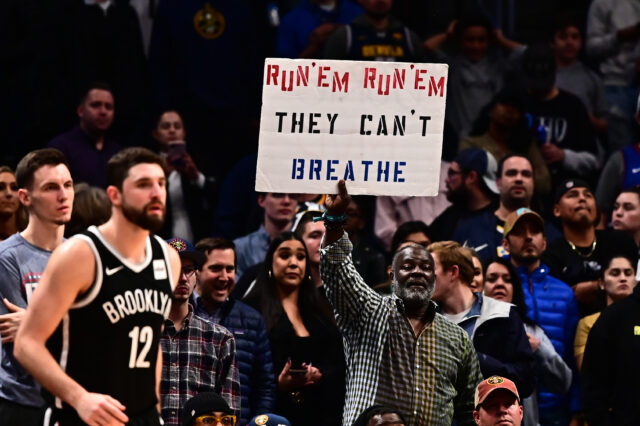 General view as a Denver Nuggets fan holds up a sign in reference to the elevation inside the Pepsi Center during the fourth quarter Brooklyn Nets.