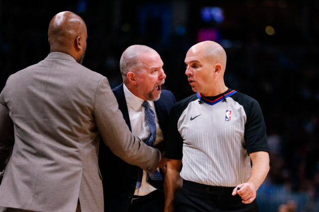Denver Nuggets head coach Michael Malone (C) argues a call with referee Jaclyn Goble (R) as assistant coach Wes Unseld Jr. (L) holds him back in the fourth quarter against the Houston Rockets at the Pepsi Center