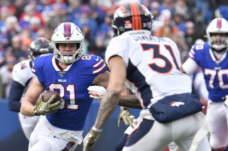 Orchard Park, NY, USA; Buffalo Bills tight end Tyler Kroft (81) looks to avoid a tackle by Denver Broncos free safety Justin Simmons (31) in the first quarter at New Era Field.