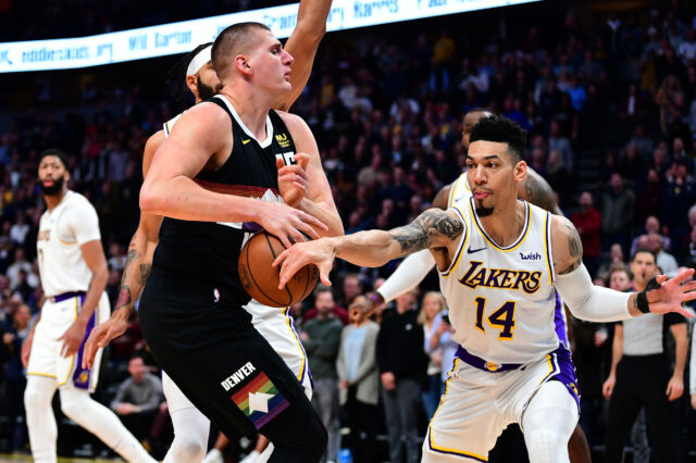 Los Angeles Lakers guard Danny Green (14) knocks the ball away from Denver Nuggets center Nikola Jokic (15) in the first quarter at the Pepsi Center.