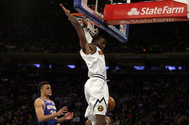 New York, NY, USA; Denver Nuggets guard Will Barton (5) slam dunks the ball over New York Knicks forward Kevin Knox II (20) during the first half at Madison Square Garden.