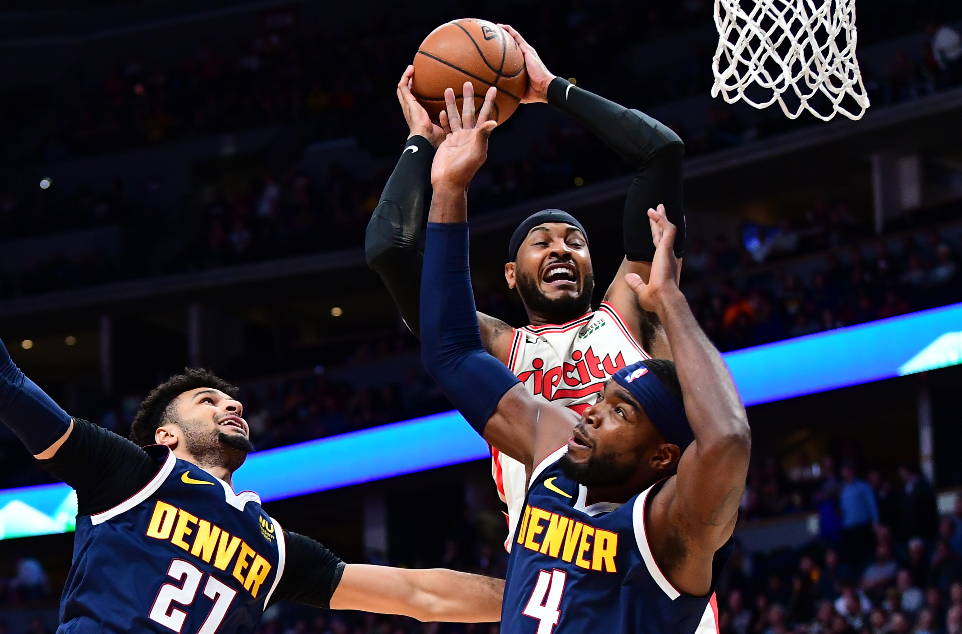 NBA: Portland Trail Blazers at Denver Nuggets Portland Trail Blazers forward Carmelo Anthony (00) pulls a rebound away from Denver Nuggets guard Jamal Murray (27) and forward Paul Millsap (4) in the first quarter at the Pepsi Center.