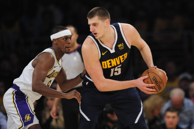 Denver Nuggets center Nikola Jokic (15) controls the ball against Los Angeles Lakers guard Rajon Rondo (9) during the second half at Staples Center.