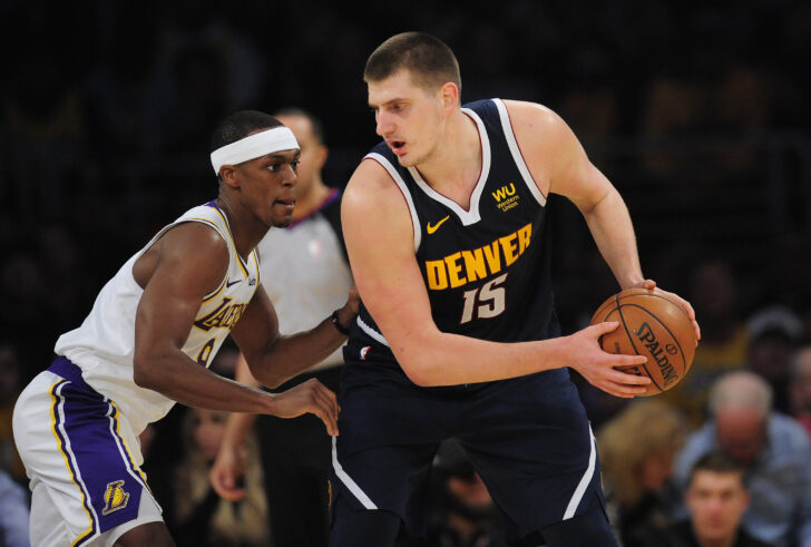 Denver Nuggets center Nikola Jokic (15) controls the ball against Los Angeles Lakers guard Rajon Rondo (9) during the second half at Staples Center.