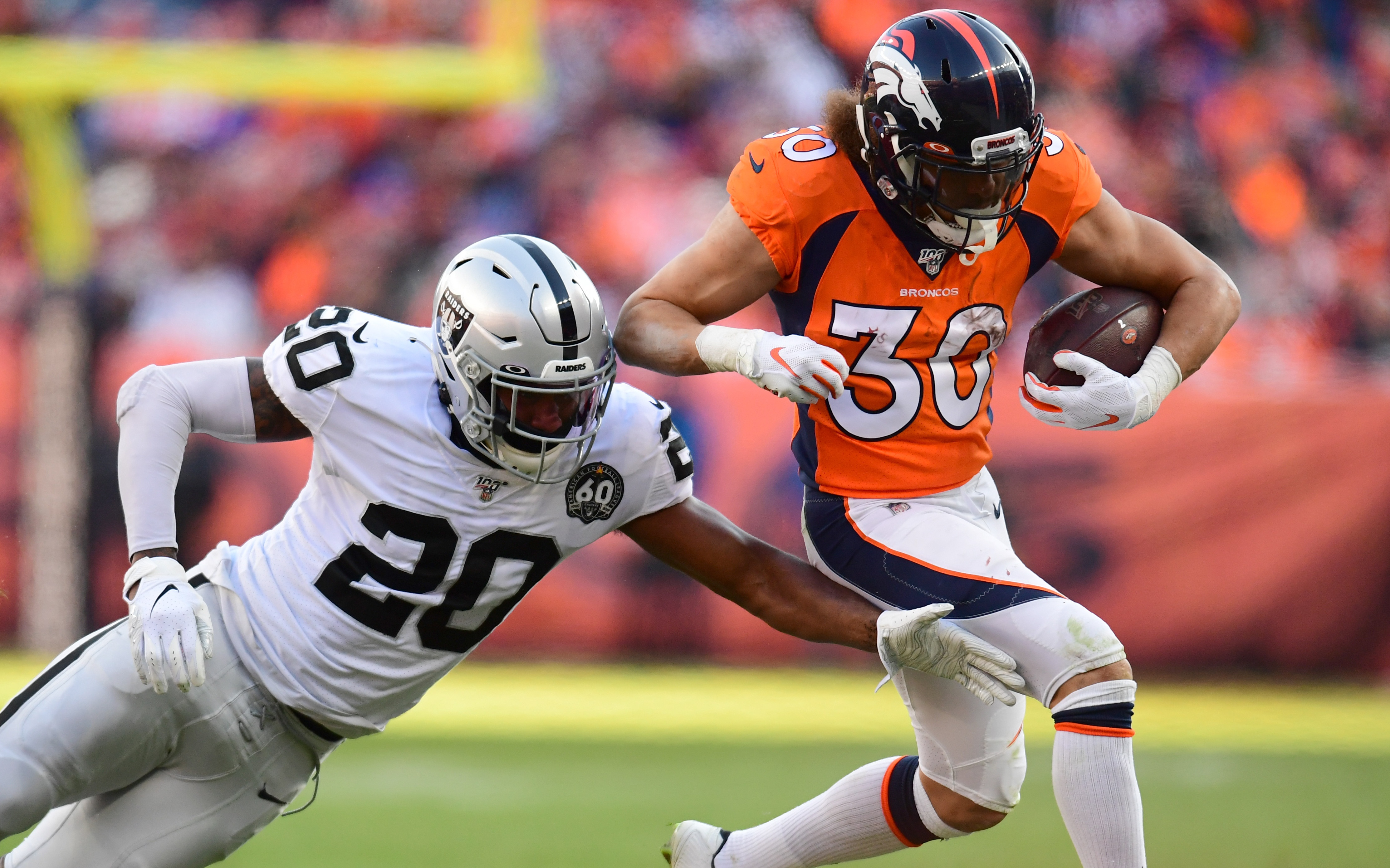 USATSI_13850335 Cropped Phillip Lindsay runs away from a Raiders defender on Sunday. Credit: Ron Chenoy, USA TODAY Sports.