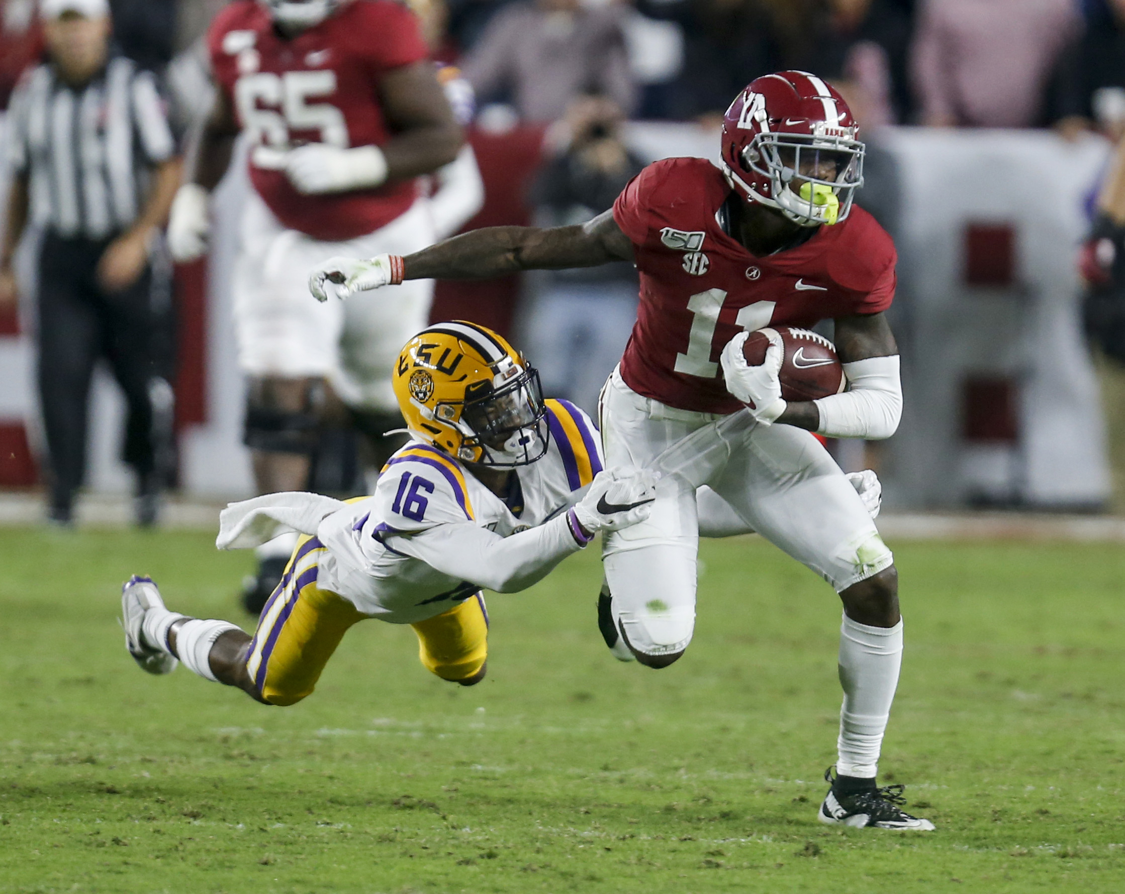 NCAA Football: Louisiana State at Alabama LSU Tigers cornerback Jay Ward (16) tries to bring down Alabama Crimson Tide wide receiver Henry Ruggs III (11) after a reception during the second half of an NCAA college football game at Bryant-Denny Stadium