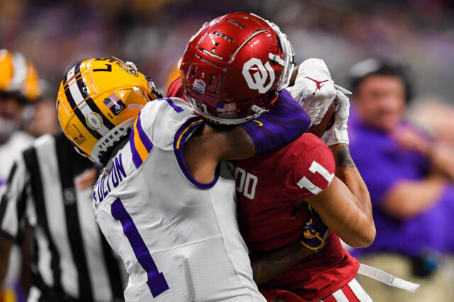 LSU Tigers cornerback Kristian Fulton (1) defends Oklahoma Sooners wide receiver Jadon Haselwood (11) on a catch during the fourth quarter of the 2019 Peach Bowl college football playoff semifinal game at Mercedes-Benz Stadium.