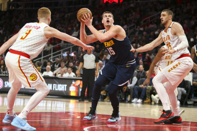 Denver Nuggets center Nikola Jokic (15) shoots against the Atlanta Hawks in the first half at State Farm Arena.
