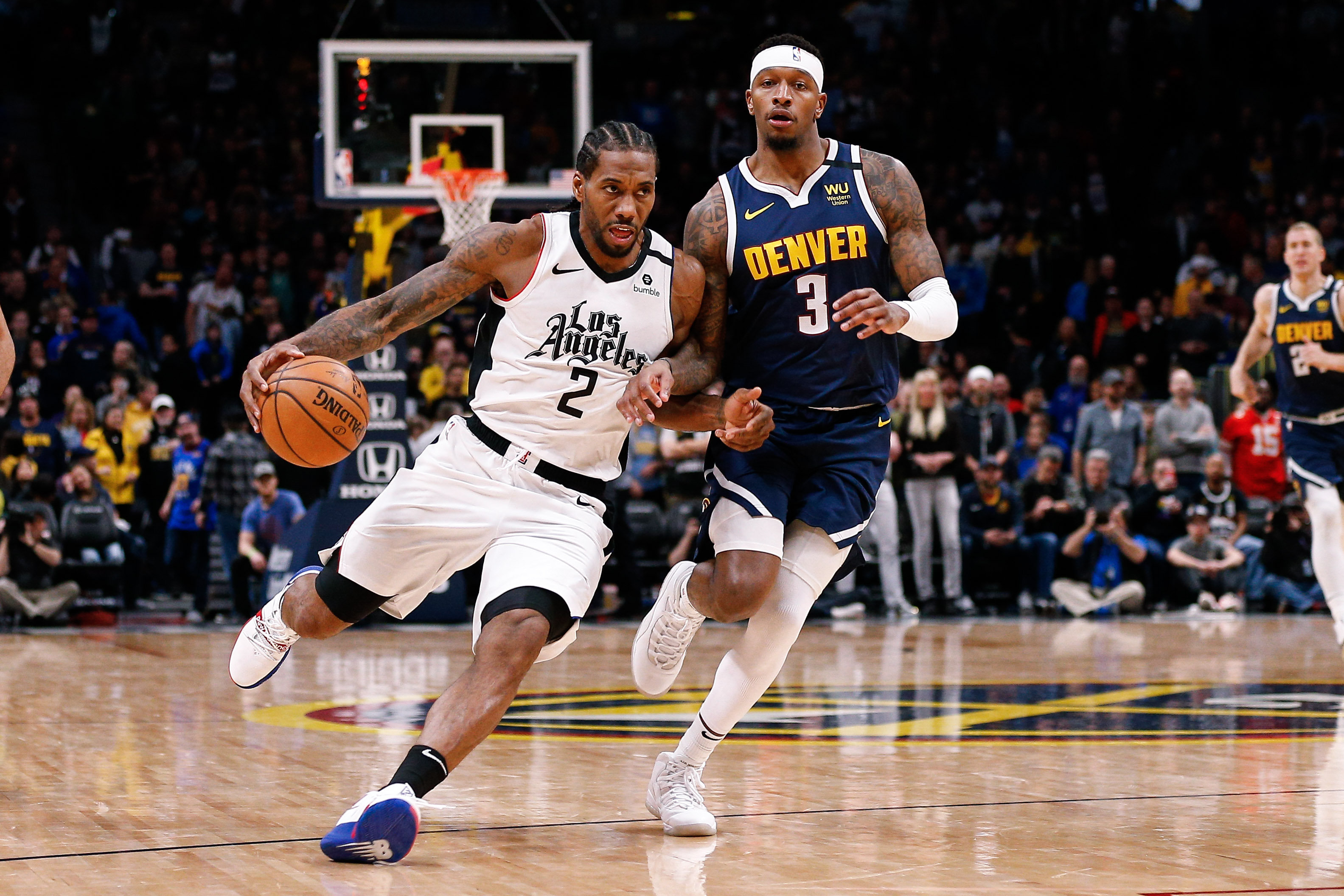 NBA: Los Angeles Clippers at Denver Nuggets Los Angeles Clippers forward Kawhi Leonard (2) drives to the net against Denver Nuggets forward Torrey Craig (3) in the fourth quarter at the Pepsi Center.