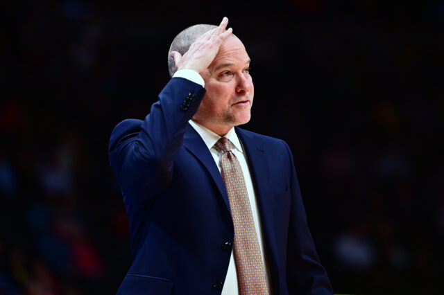 Denver Nuggets head coach Michael Malone wipes his head during the second half against the Charlotte Hornets at the Pepsi Center.