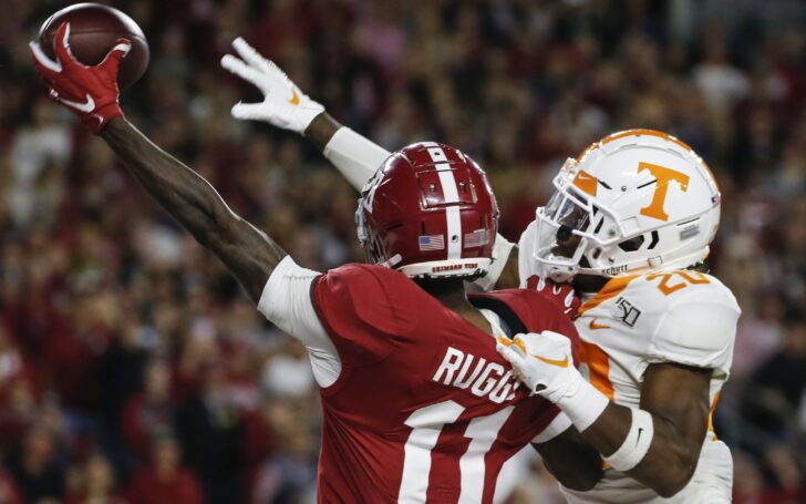 Henry Ruggs catches a pass with a defender draped on his back. Credit: Butch Dill, USA TODAY Sports.
