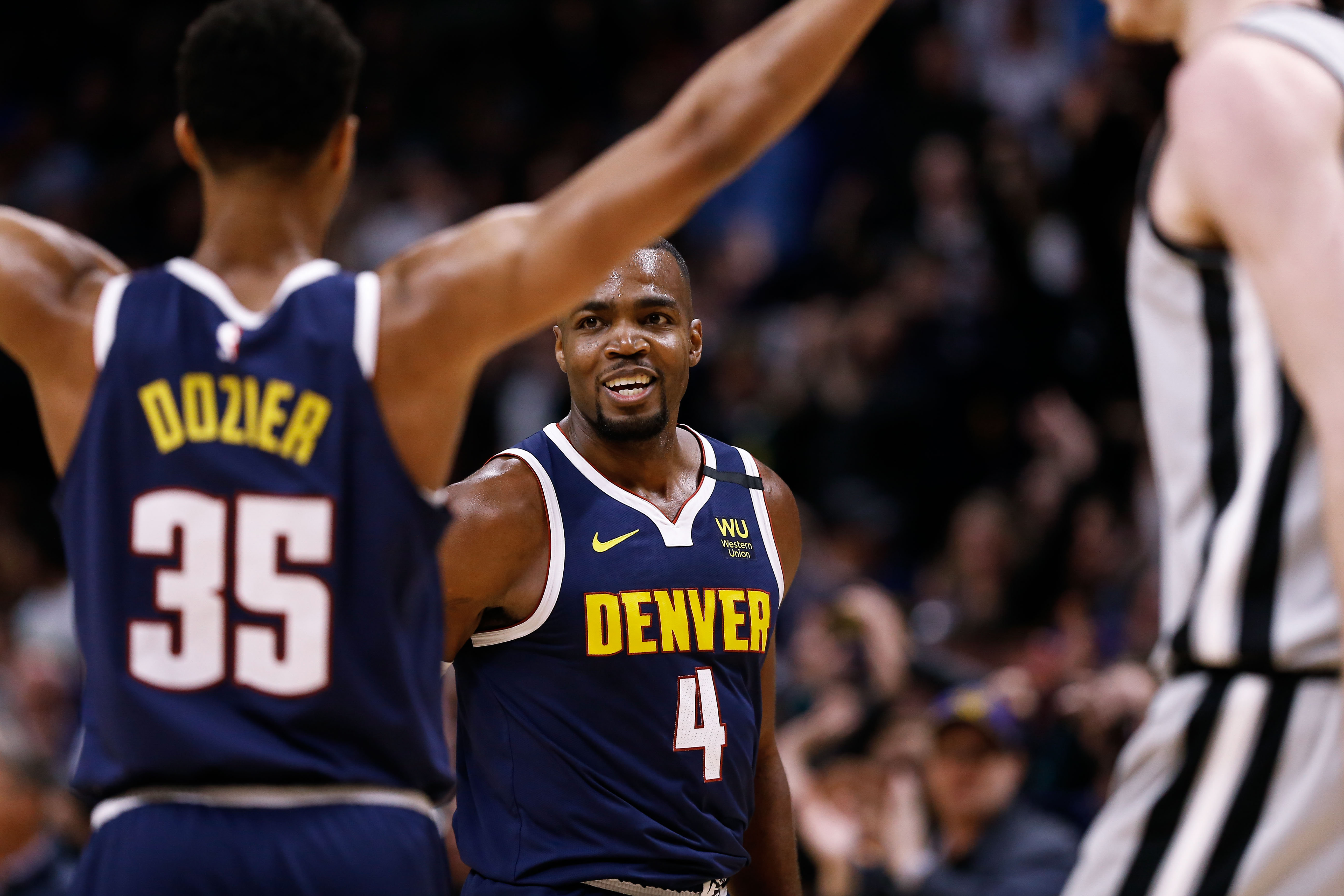 Denver Nuggets forward Paul Millsap (4) celebrates with guard PJ Dozier (35) in the fourth quarter against the San Antonio Spurs at the Pepsi Center.