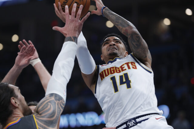 Denver Nuggets guard Gary Harris (14) drives to the goal against Oklahoma City Thunder center Steven Adams (12) during the first quarter at Chesapeake Energy Arena.