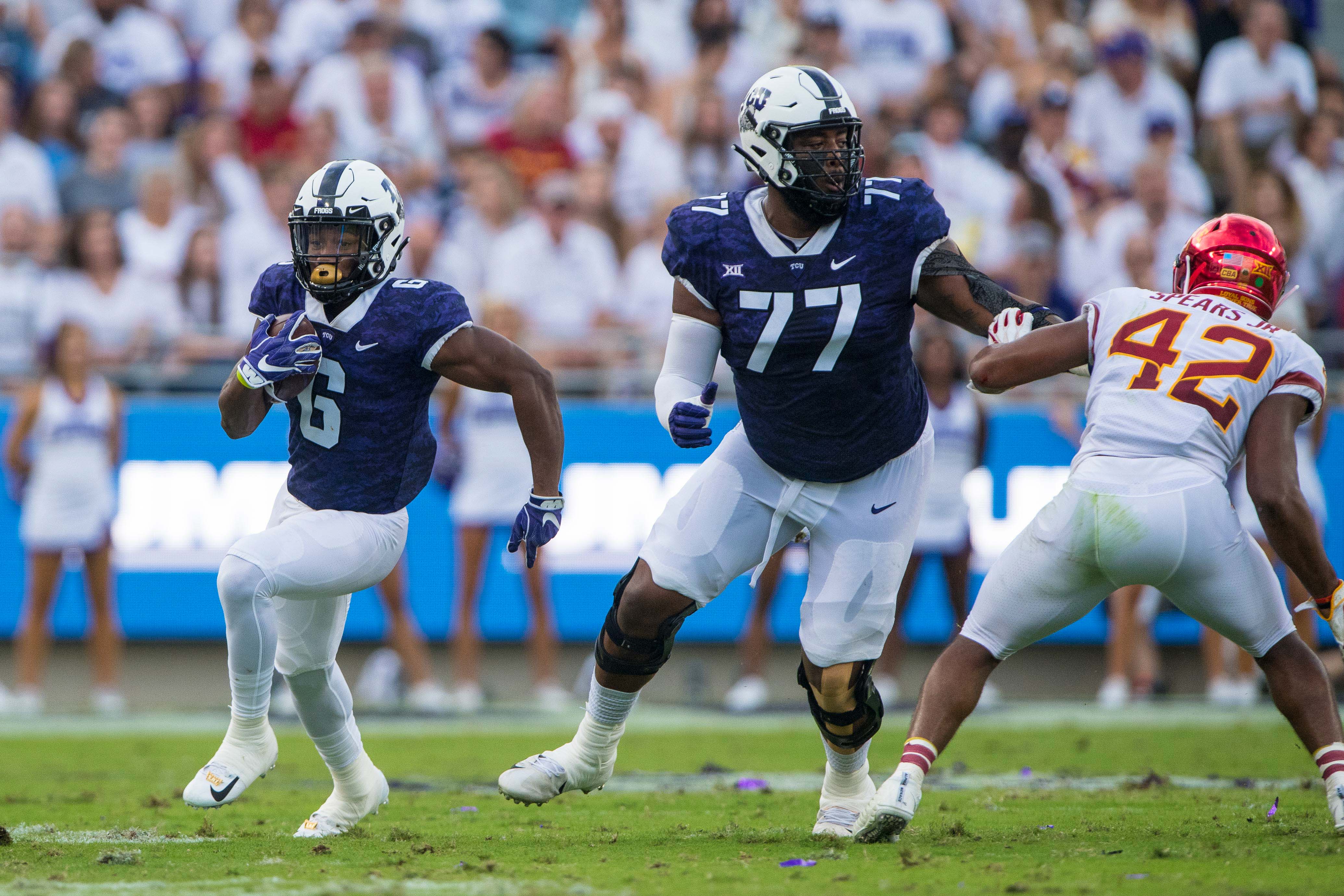 TCU Horned Frogs running back Darius Anderson (6) and offensive tackle Lucas Niang (77) in action during the game against the Iowa State Cyclones at Amon G. Carter Stadium.