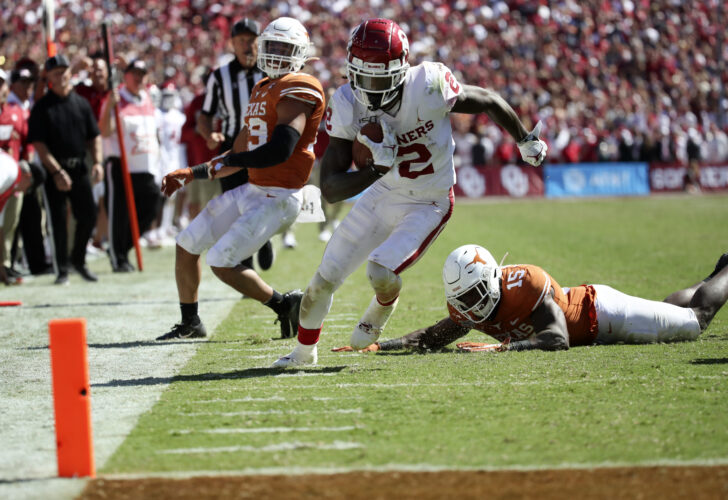 Oklahoma Sooners wide receiver CeeDee Lamb (2) runs over Texas Longhorns defensive back Chris Brown (15) and scores a touchdown during the second half at the Cotton Bowl.
