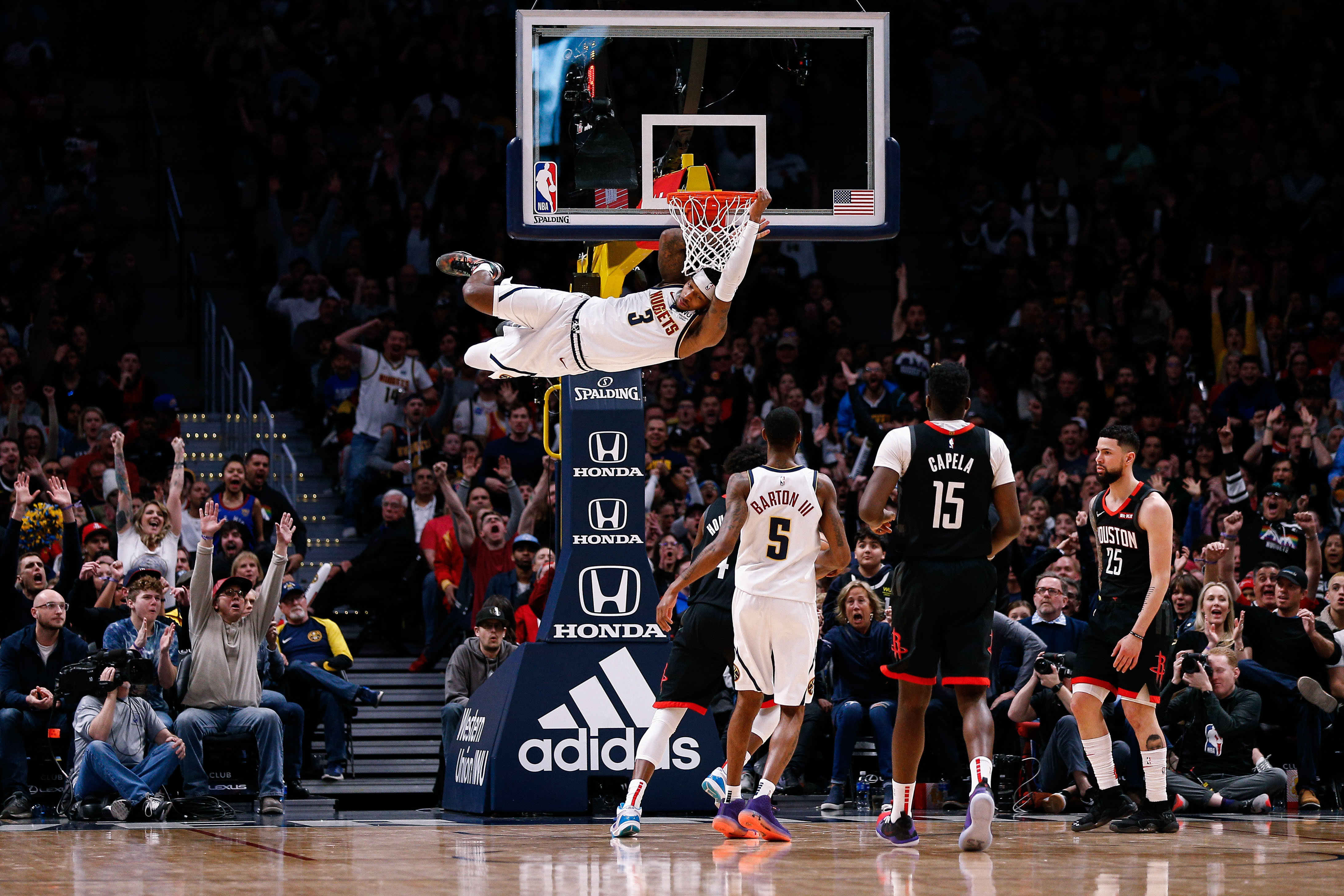 NBA: Houston Rockets at Denver Nuggets Denver Nuggets forward Torrey Craig (3) hangs off the rim after dunking the ball as forward Will Barton III (5) and Houston Rockets center Clint Capela (15) and guard Austin Rivers (25) look on in the fourth quarter at the Pepsi Center.