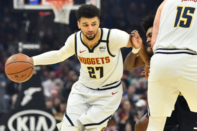 Denver Nuggets guard Jamal Murray (27) drives to the basket against as center Nikola Jokic (15) sets a screen on Cleveland Cavaliers guard Collin Sexton (2) during the first half at Rocket Mortgage FieldHouse.