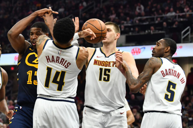 Cleveland Cavaliers center Tristan Thompson (13) and Denver Nuggets guard Gary Harris (14) and center Nikola Jokic (15) and forward Will Barton (5) battle for a rebound during the second half at Rocket Mortgage FieldHouse.