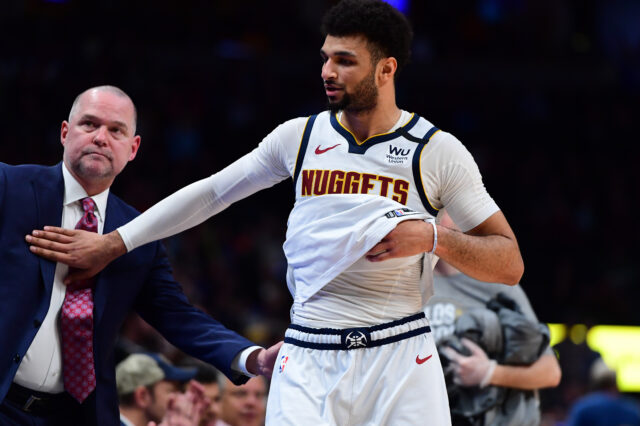 Denver Nuggets guard Jamal Murray (27) and head coach Michael Malone celebrate defeating the Milwaukee Bucks at the Pepsi Center.