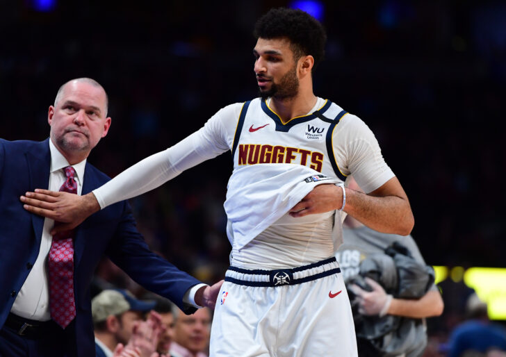 Denver Nuggets guard Jamal Murray (27) and head coach Michael Malone celebrate defeating the Milwaukee Bucks at the Pepsi Center.