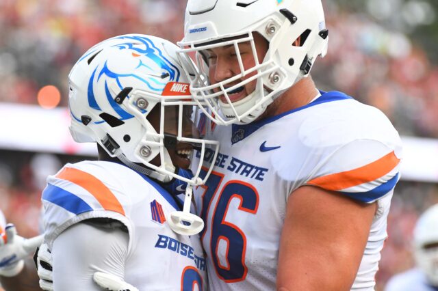 Boise State Broncos wide receiver CT Thomas (6) celebrates with Boise State Broncos offensive lineman Ezra Cleveland (76) after a touchdown during the first half against the Troy Trojans at Veterans Memorial Stadium.