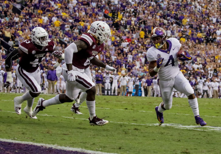 LSU Tigers running back Nick Brossette (4) is pursued by Mississippi State Bulldogs linebacker Willie Gay Jr. (6) during the first quarter at Tiger Stadium