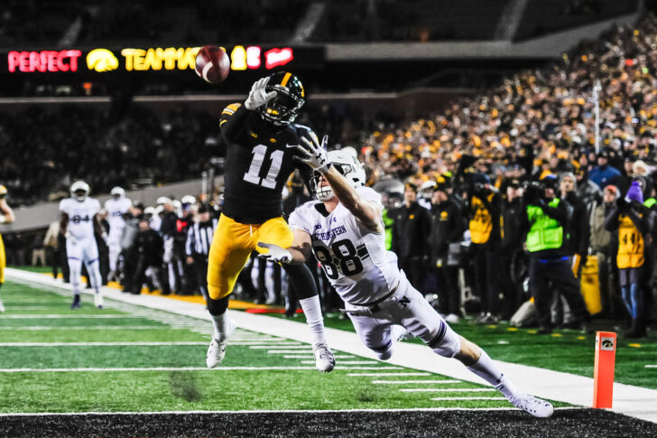 Northwestern Wildcats wide receiver Bennett Skowronek (88) reaches for a touchdown catch as Iowa Hawkeyes defensive back Michael Ojemudia (11) defends during the fourth quarter at Kinnick Stadium.