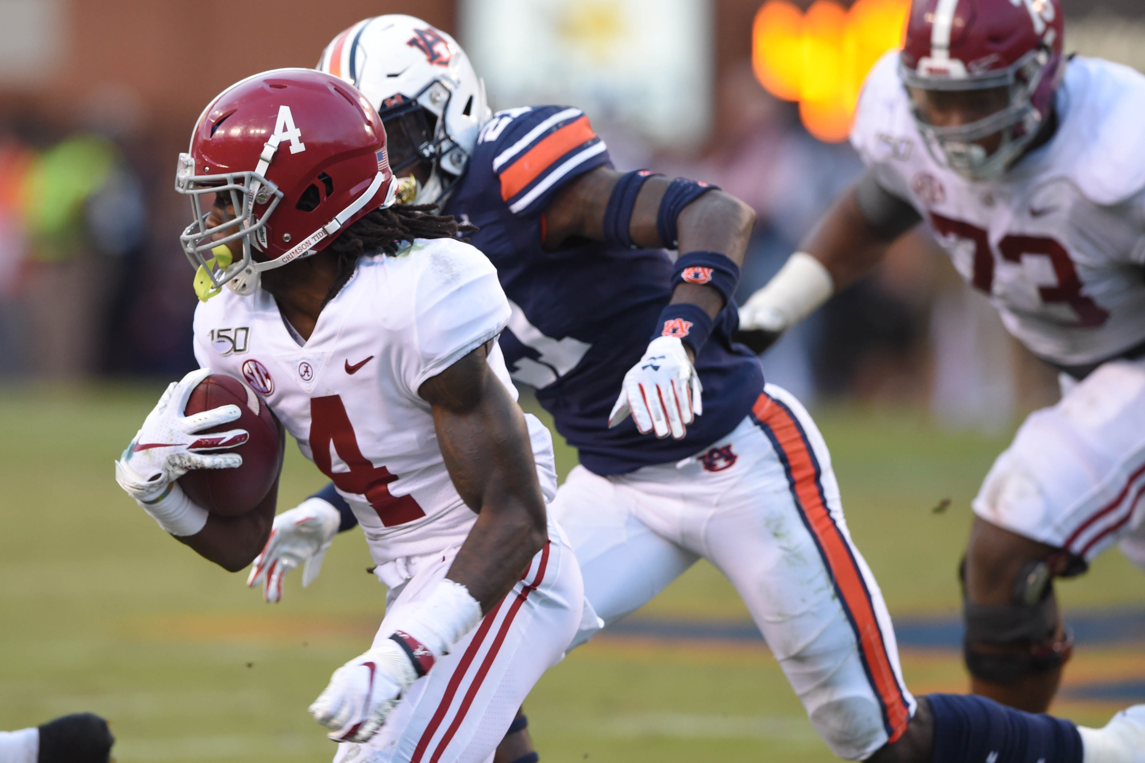 NCAA Football: Alabama at Auburn Alabama Crimson Tide wide receiver Jerry Jeudy (4) runs the ball ahead of Auburn Tigers defensive back Smoke Monday (21) during the second quarter at Jordan-Hare Stadium.