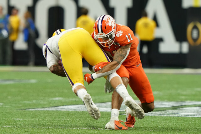 Clemson Tigers linebacker Isaiah Simmons (11) tackles LSU Tigers tight end Thaddeus Moss (81) in the first quarter in the College Football Playoff national championship game at Mercedes-Benz Superdome.