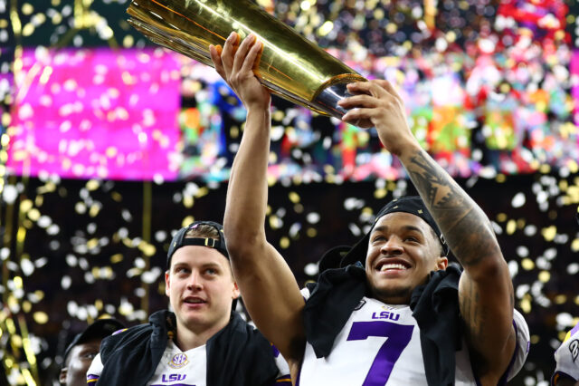 LSU Tigers safety Grant Delpit (7) hoists the national championship trophy after a victory against the Clemson Tigers in the College Football Playoff national championship game at Mercedes-Benz Superdome.