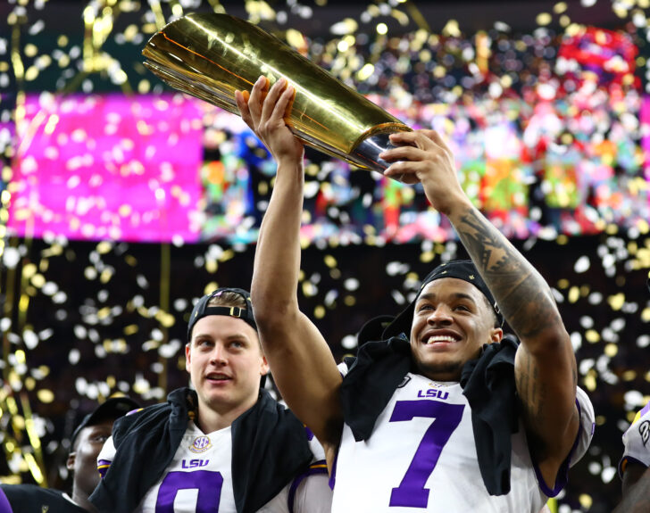 LSU Tigers safety Grant Delpit (7) hoists the national championship trophy after a victory against the Clemson Tigers in the College Football Playoff national championship game at Mercedes-Benz Superdome.