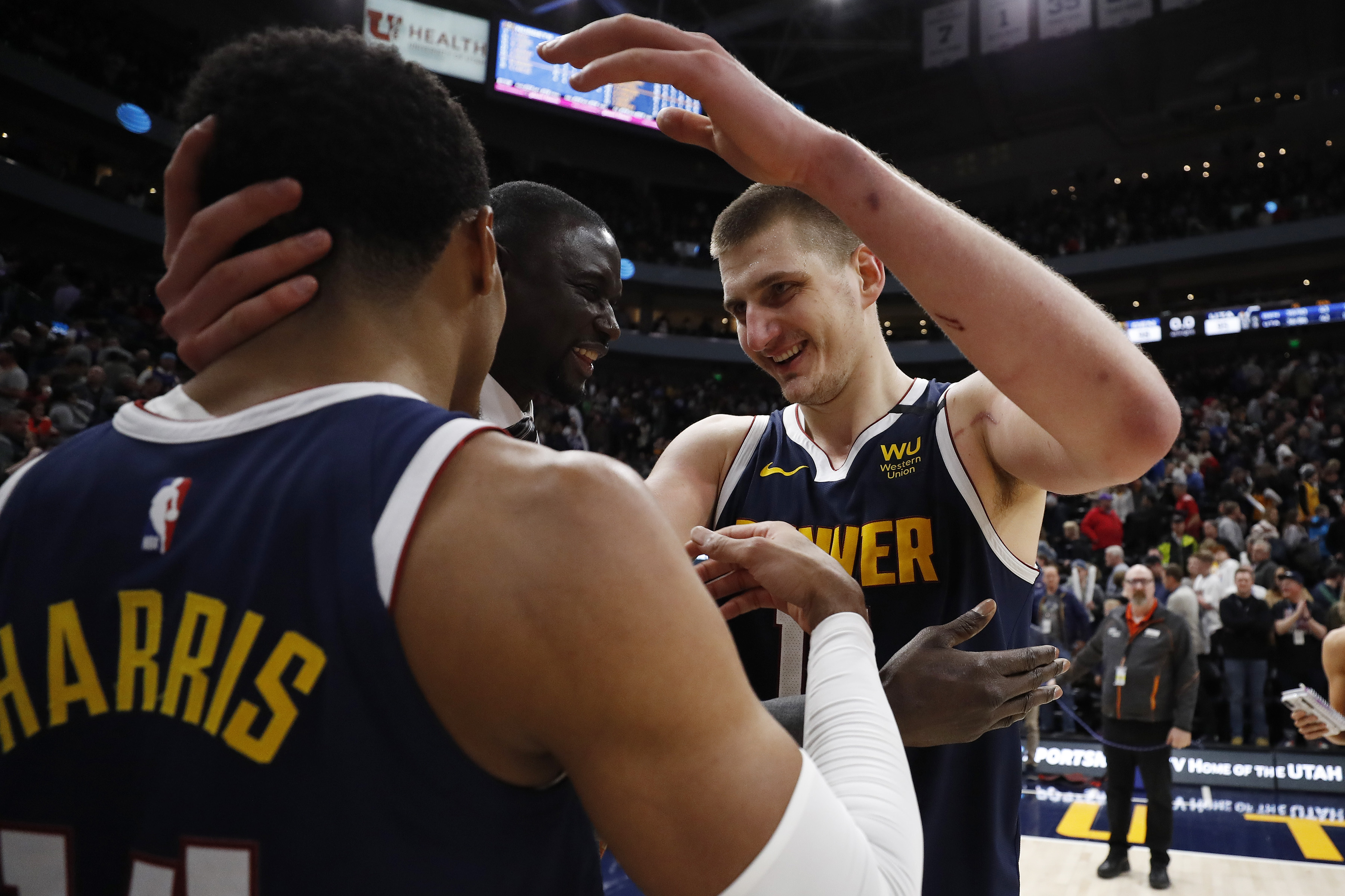 Denver Nuggets center Nikola Jokic (15), right celebrates with guard Gary Harris (14) after their win against the Utah Jazz at Vivint Smart Home Arena.