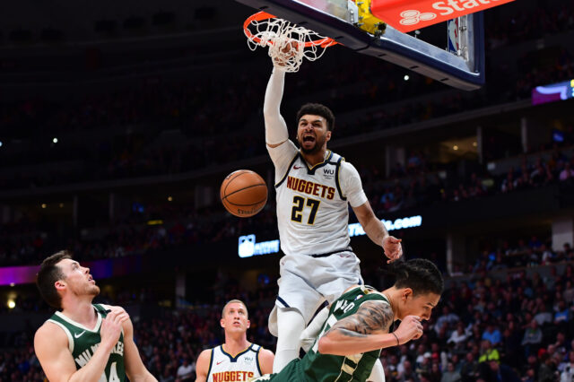 Denver Nuggets guard Jamal Murray (27) finishes off a basket over Milwaukee Bucks forward D.J. Wilson (5) in the third quarter at the Pepsi Center