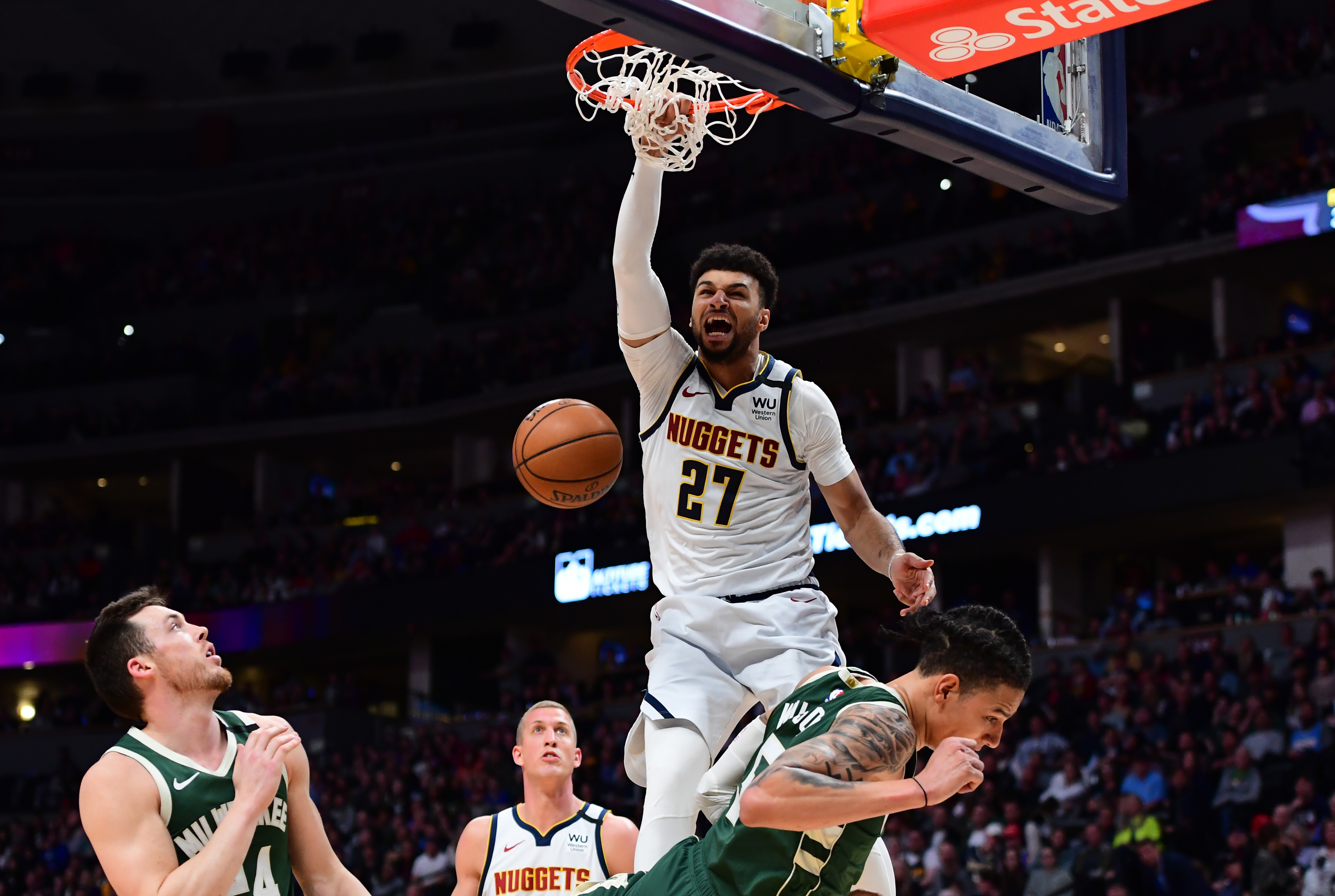 NBA: Milwaukee Bucks at Denver Nuggets Denver Nuggets guard Jamal Murray (27) finishes off a basket over Milwaukee Bucks forward D.J. Wilson (5) in the third quarter at the Pepsi Center