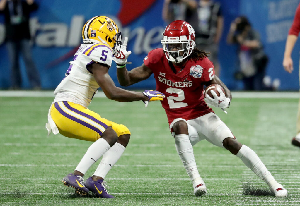 Oklahoma Sooners wide receiver CeeDee Lamb (2) runs against LSU Tigers Kary Vincent Jr. (5) during the 2019 Peach Bowl college football playoff semifinal game between the LSU Tigers and the Oklahoma Sooners at Mercedes-Benz Stadium.