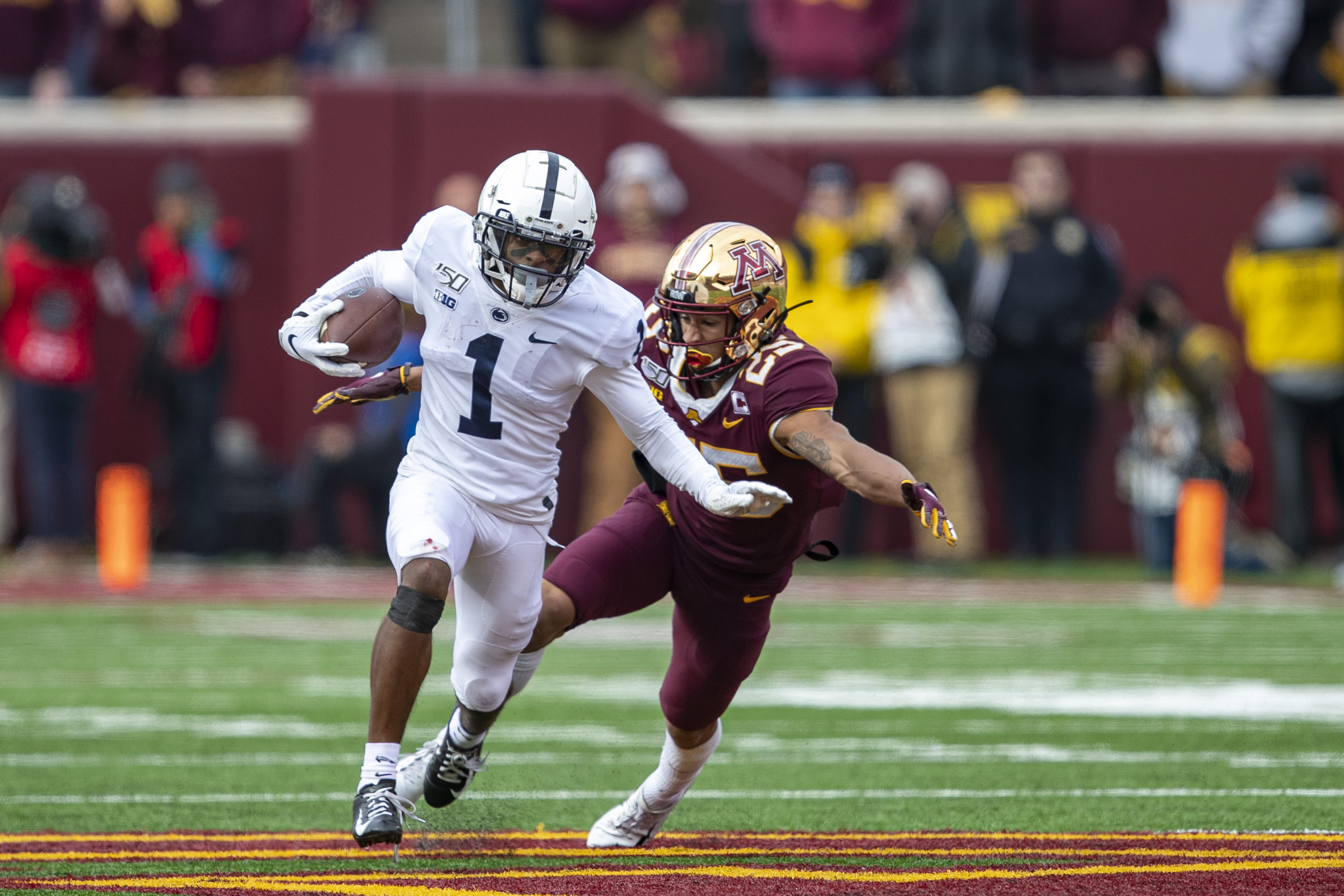 NCAA Football: Penn State at Minnesota Penn State Nittany Lions wide receiver KJ Hamler (1) rushes with the ball after making a catch as Minnesota Golden Gophers defensive back Benjamin St-Juste (25) attempts to make a tackle in the first half at TCF Bank Stadium.