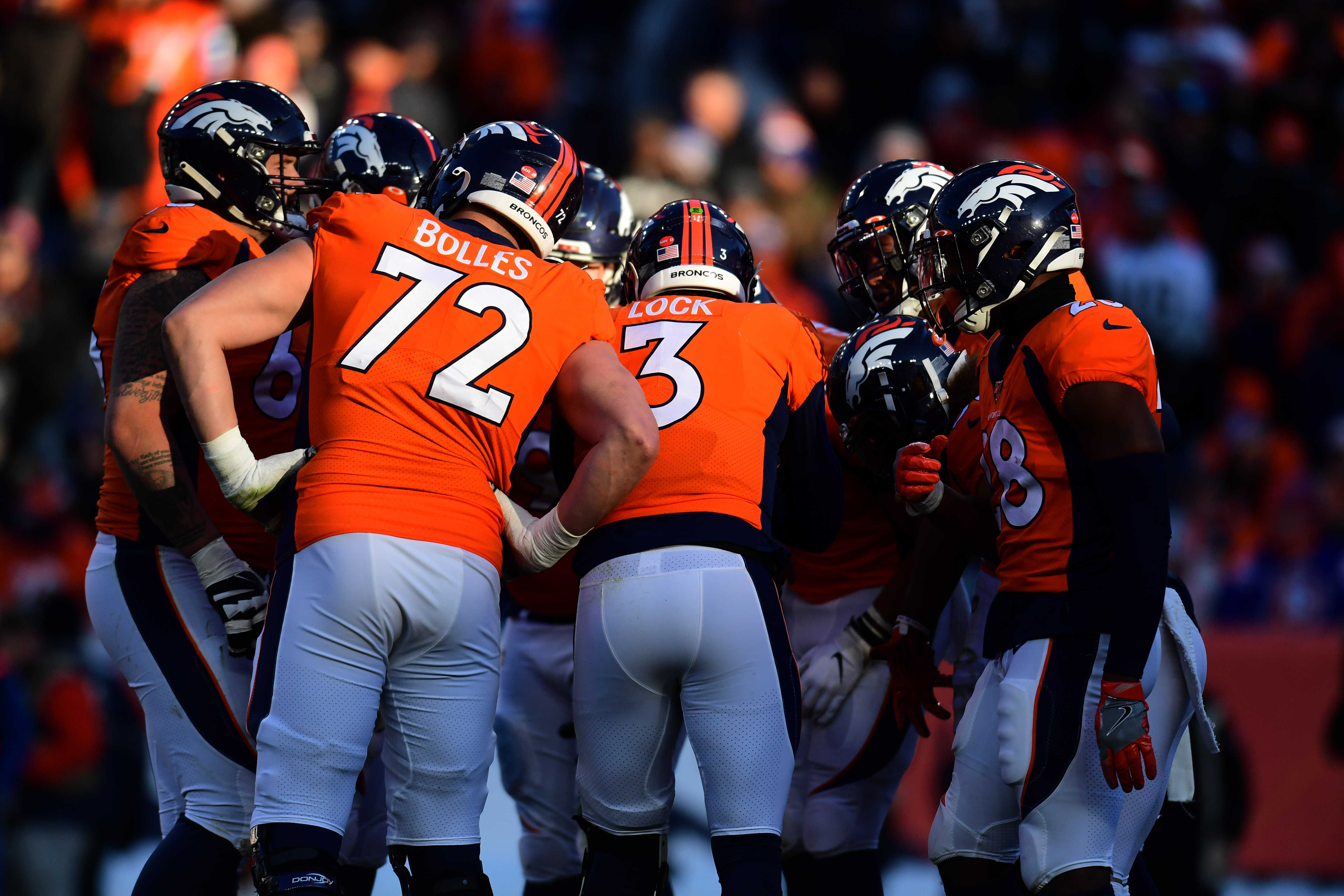 Denver Broncos quarterback Drew Lock (3) huddles with teammates in the second quarter against the Oakland Raiders at Empower Field at Mile High.