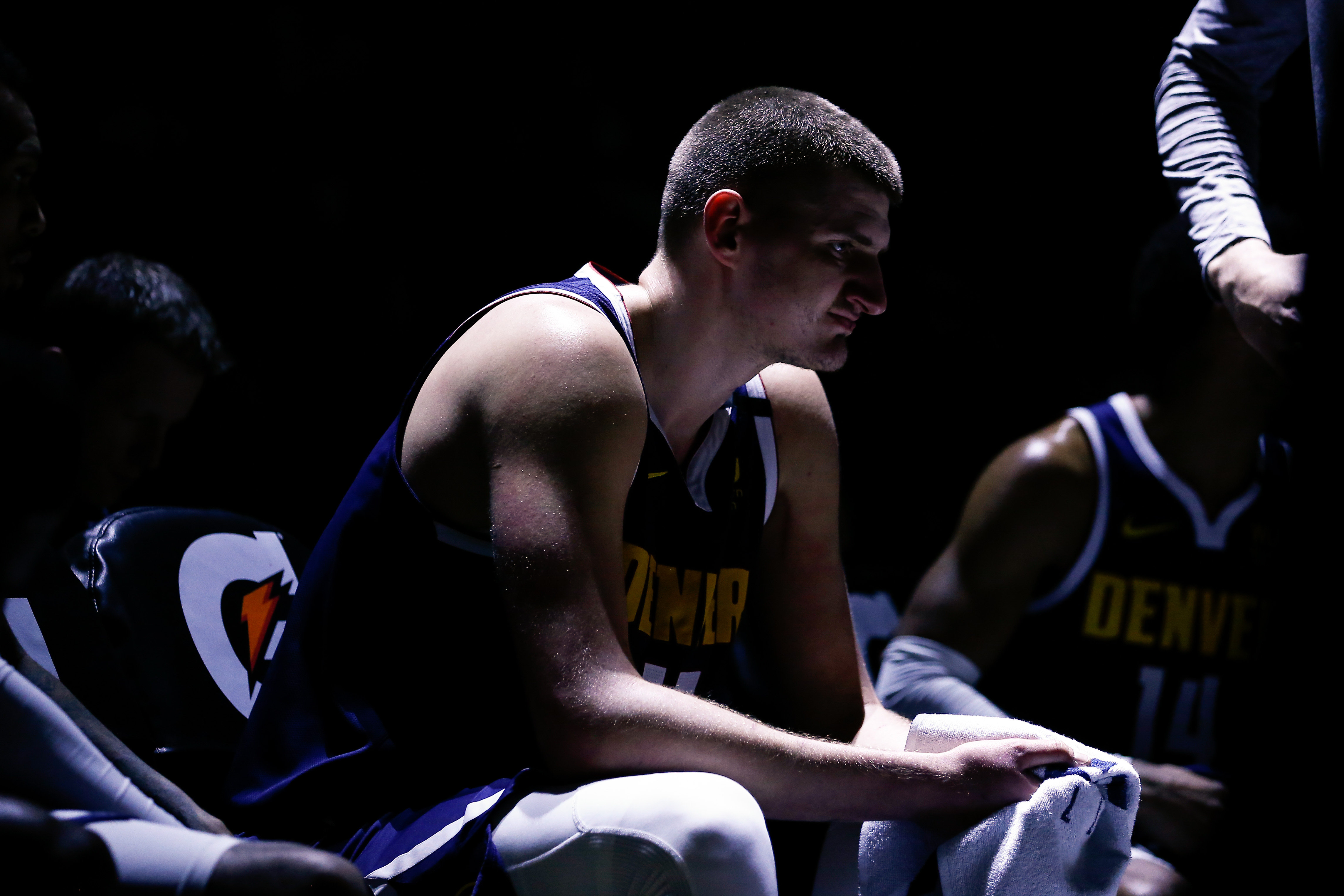 Denver Nuggets center Nikola Jokic (15) sits on the bench in the third quarter against the Golden State Warriors at the Pepsi Center.
