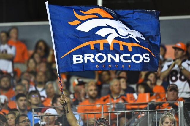 Broncos fans fly a flag. Credit: Ron Chenoy, USA TODAY Sports.