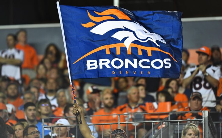 Broncos fans fly a flag. Credit: Ron Chenoy, USA TODAY Sports.