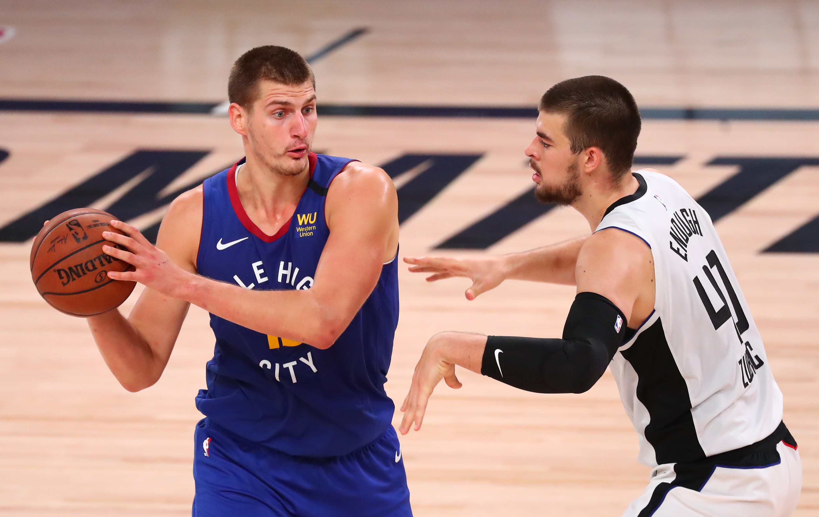 Denver Nuggets center Nikola Jokic (15) is defended by LA Clippers center Ivica Zubac (40) in the third quarter of a NBA basketball game at AdventHealth Arena.
