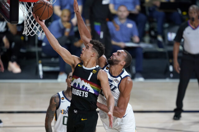Denver Nuggets' Michael Porter Jr. (1) shoots past Utah Jazz's Rudy Gobert during the second half of an NBA basketball first round playoff game.