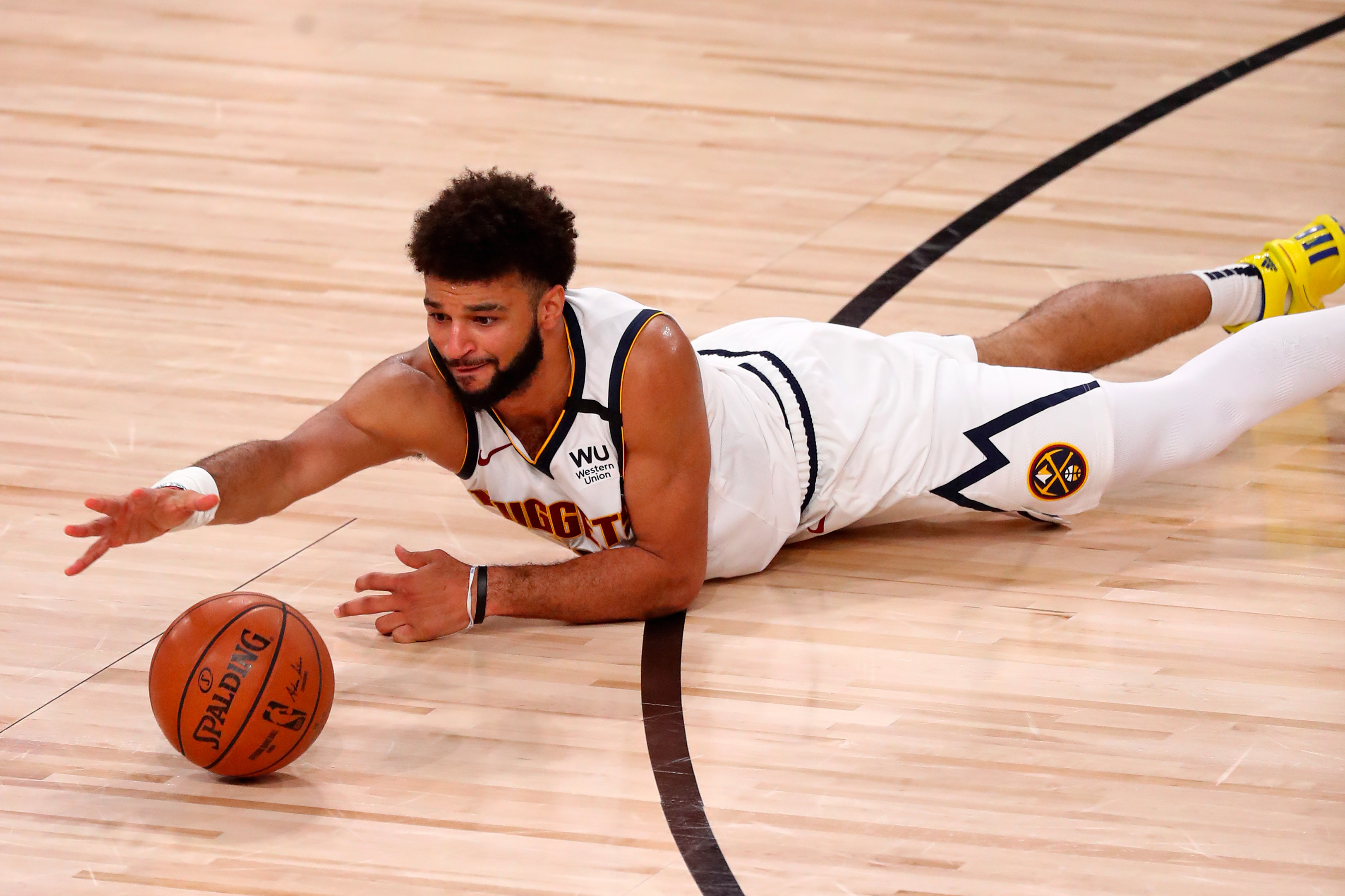 Denver Nuggets guard Jamal Murray (27) reaches for a loose ball during the first half against the LA Clippers in game one of the second round of the 2020 NBA Playoffs at AdventHealth Arena.