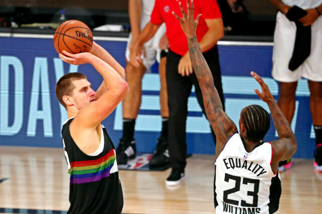 Denver Nuggets center Nikola Jokic (15) shoots the ball against LA Clippers guard Lou Williams (23) during the fourth quarter in game six of the second round of the 2020 NBA Playoffs at ESPN Wide World of Sports Complex.