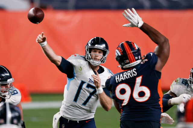 Tennessee Titans quarterback Ryan Tannehill (17) passes as Denver Broncos defensive end Shelby Harris (96) attempts to block in the fourth quarter at Empower Field at Mile High.