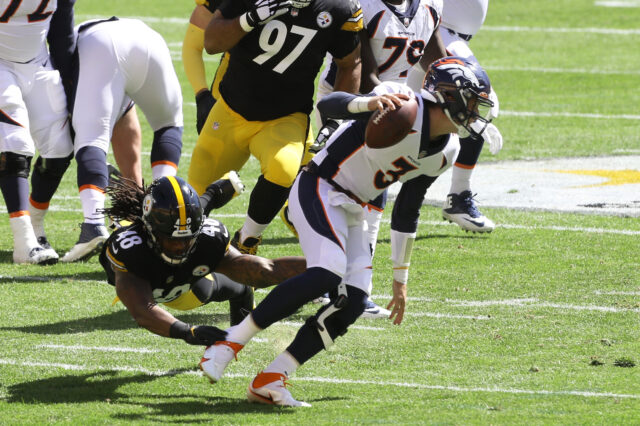 Denver Broncos quarterback Drew Lock (3) escapes the grasp of Pittsburgh Steelers outside linebacker Bud Dupree (48) during the first quarter at Heinz Field.