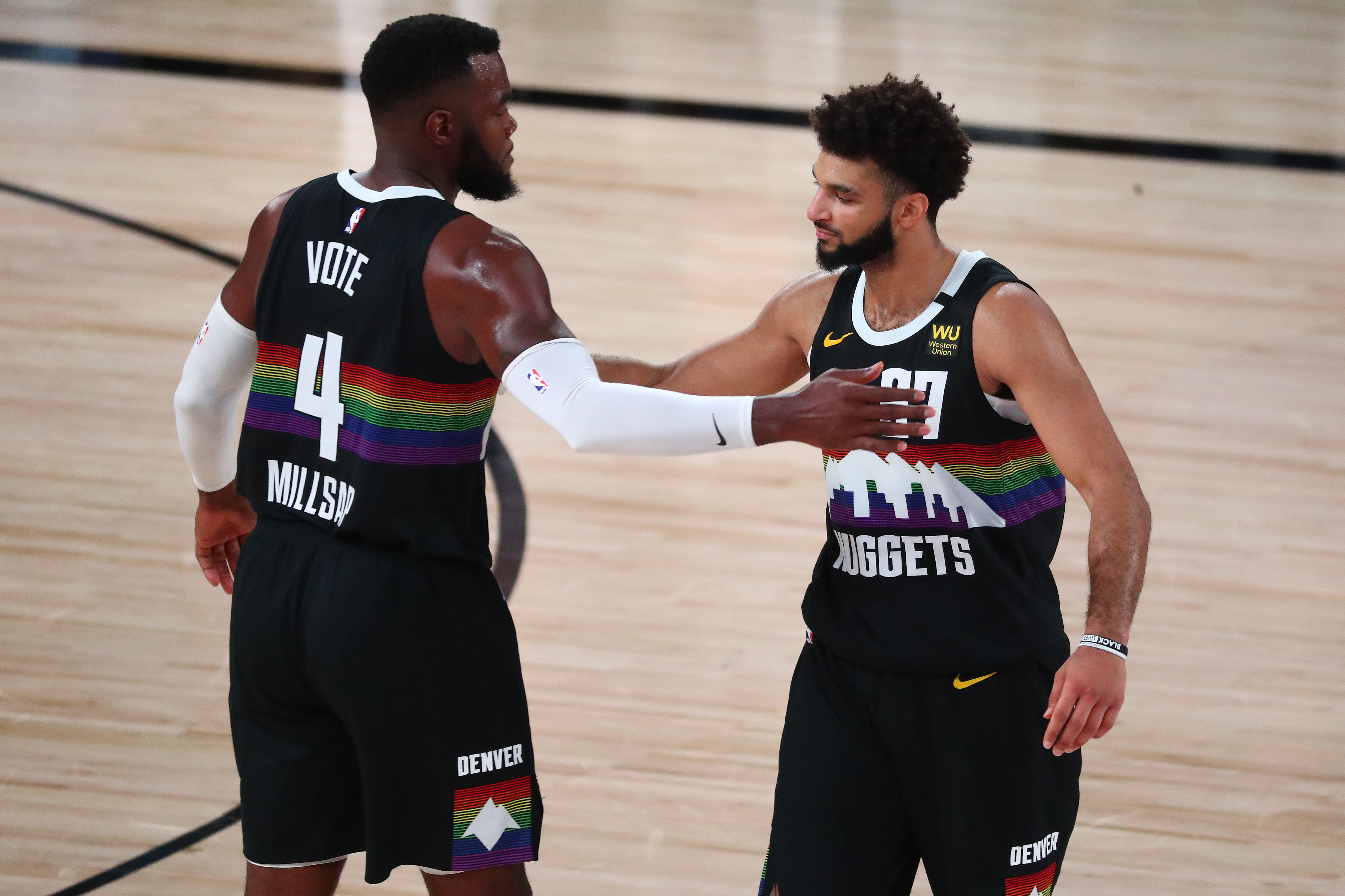 Denver Nuggets forward Paul Millsap (4) and guard Jamal Murray (27) celebrate after defeating the Los Angeles Lakers in game three of the Western Conference Finals of the 2020 NBA Playoffs at AdventHealth Arena.