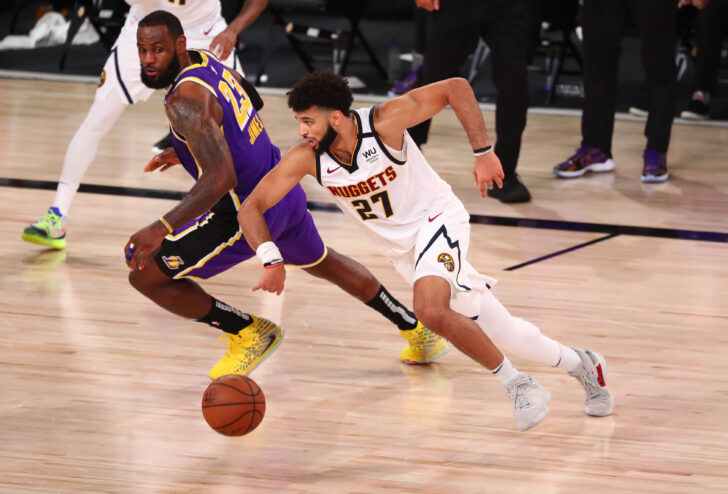 Los Angeles Lakers forward LeBron James (23) chases the ball with Denver Nuggets guard Jamal Murray (27) during the fourth quarter in game five of the Western Conference Finals of the 2020 NBA Playoffs at AdventHealth Arena.